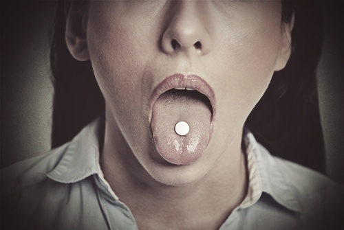 percocet addict pill on tongue