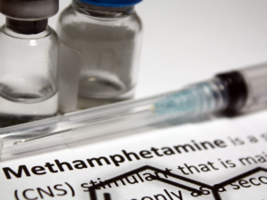 Needles and clear glass bottles are next to the word "methamphetamine."