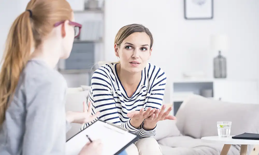 female client during personal consultation discussing care and treatment options in drug and alcohol rehab in newport beach california