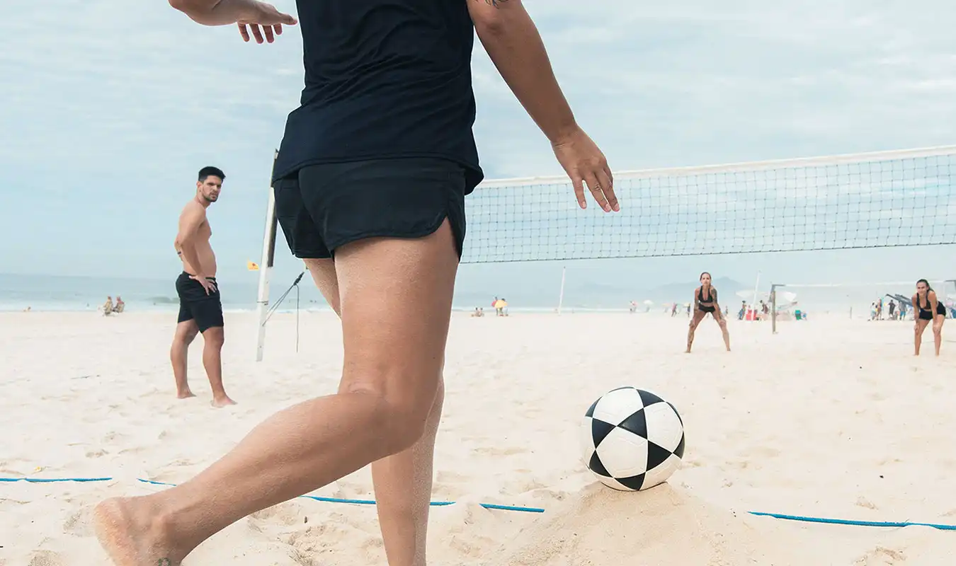 men and women playing volleyball in the beach as part of their addiction treatment at sober partners huntington beach california