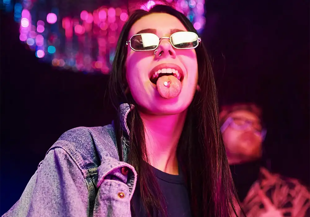 woman-showing-the-party-drug-on-her-tounge