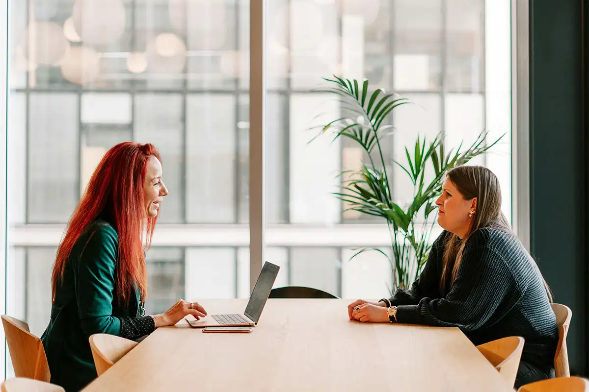woman talking to her employer about taking a her leave