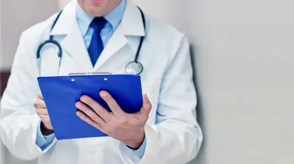 doctor-holding-a-folder-writing-prescription