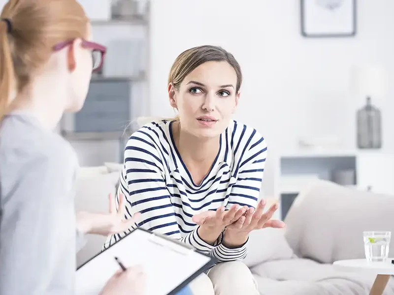 female client during personal consultation discussing care and treatment options in drug and alcohol rehab in newport beach california