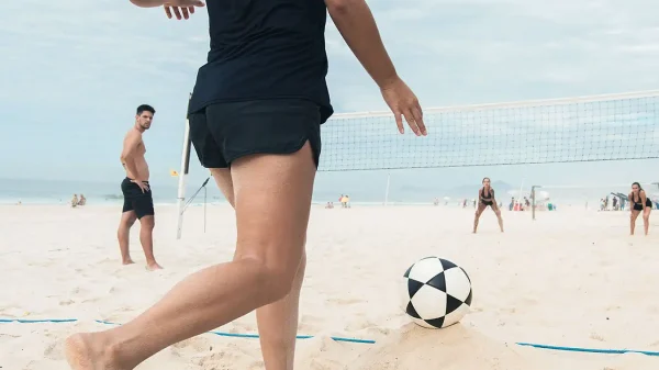 men and women playing volleyball in the beach as part of their addiction treatment at sober partners huntington beach california